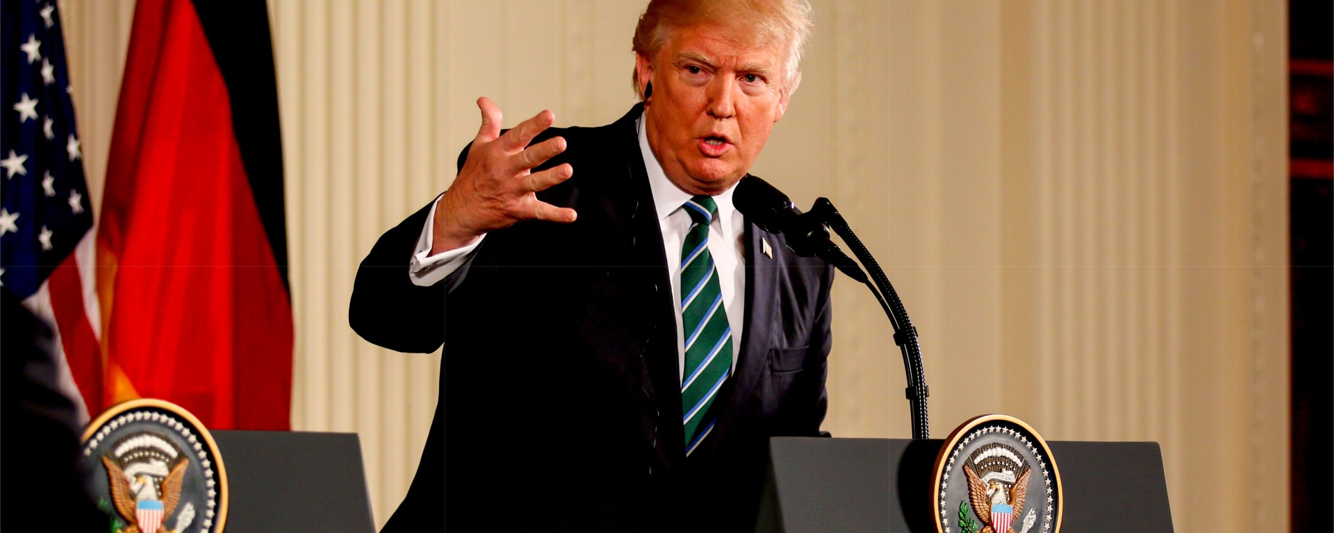 Trump giving a speech and waving his hand