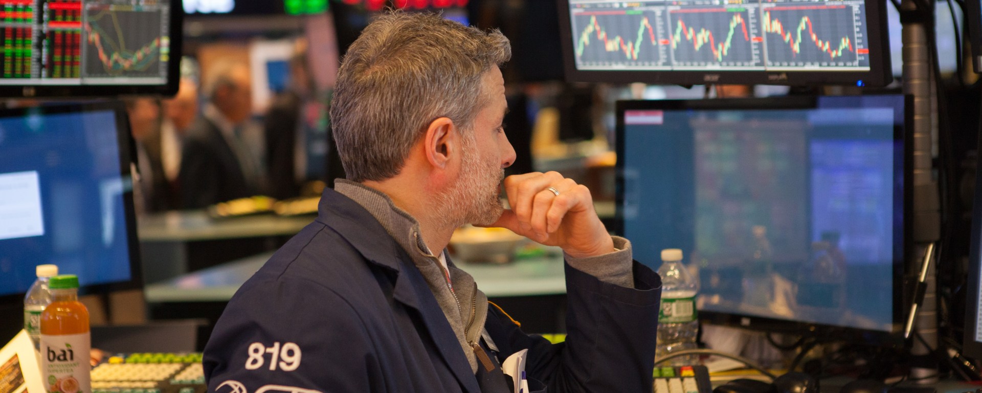 Stock broker watching screens