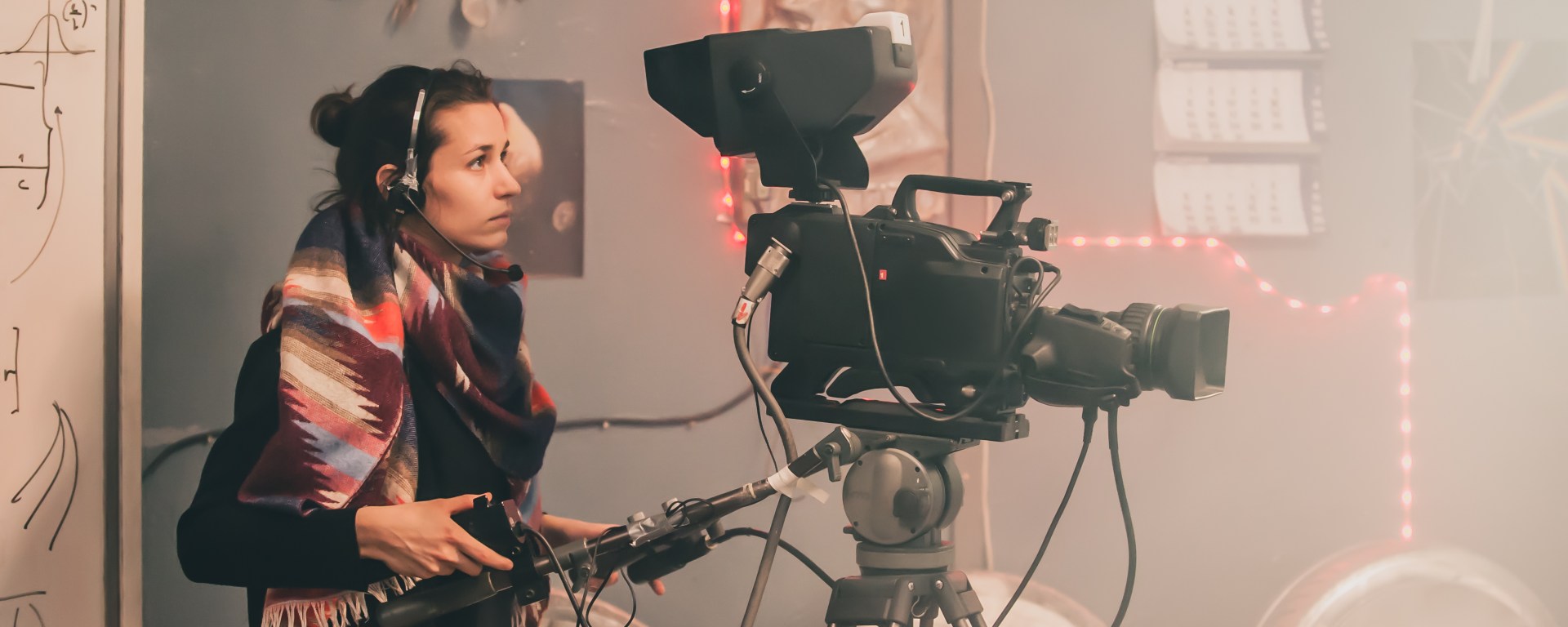 Woman holding professional video camera
