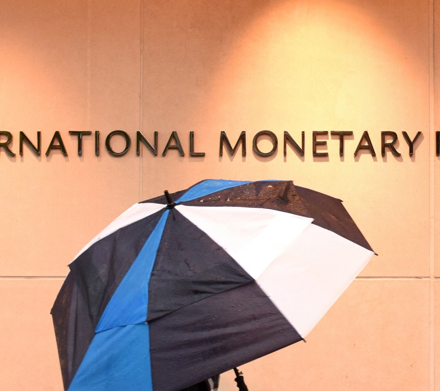 Man with Umbrella outside International Monetary Fund Building