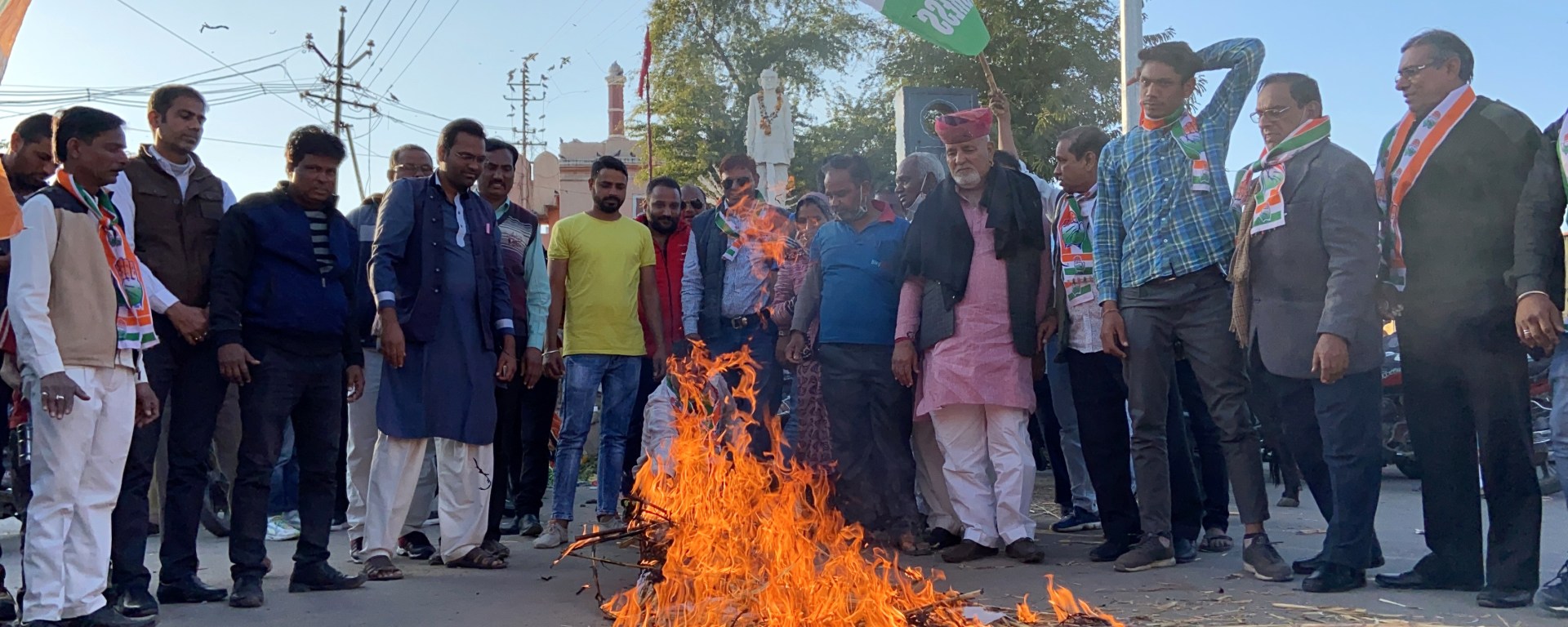 Indian men watching a bonfire on the street