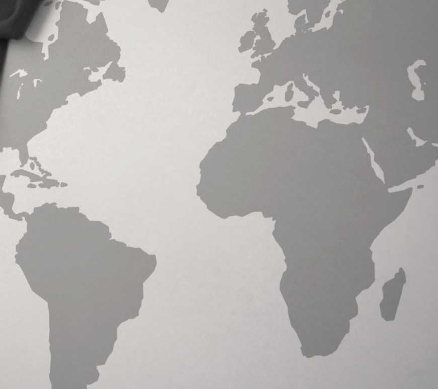 Flag of Sudan waving over grey map of the world