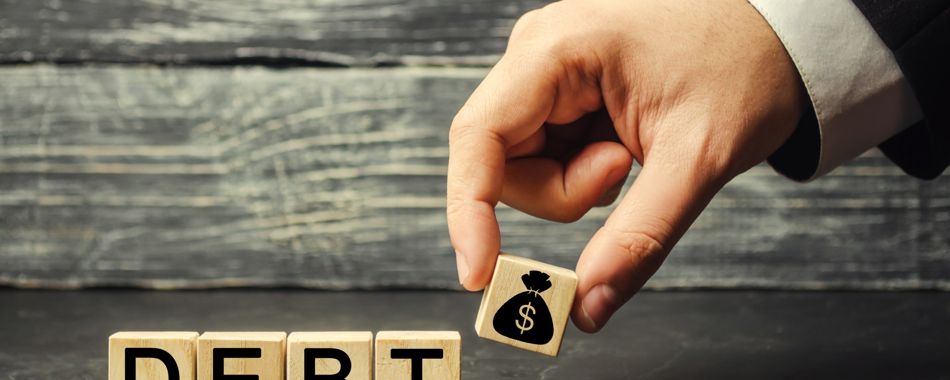 Wooden blocks spelling the word debt