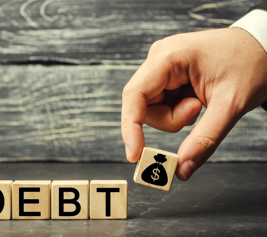 Wooden blocks spelling the word debt