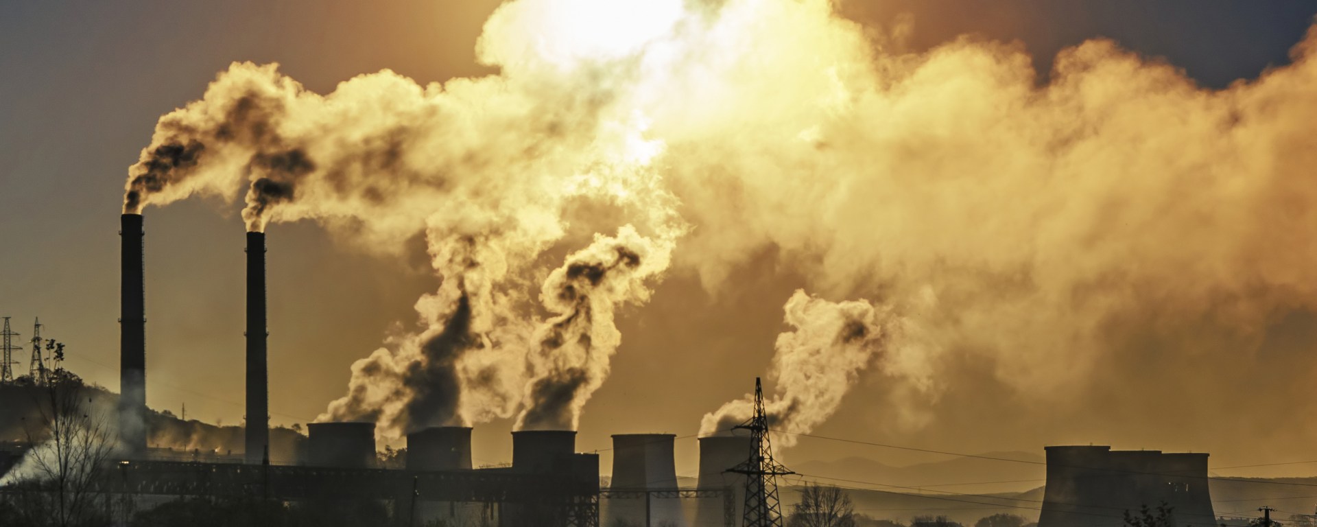 Collection of factory chimneys puffing out smoke